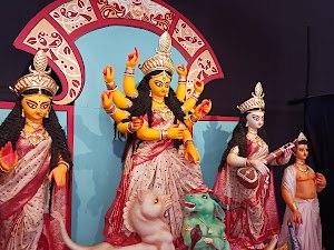 Durga idol tableau with red ceremonial backdrop, South Bangalore Cultural Association (SBCA)